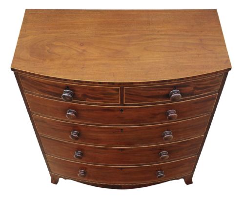 fig 2. A nineteenth century mahogany bow front chest of drawers with two short over three long graduated drawers, featuring turned timber handles and delicate boxwood stringing.