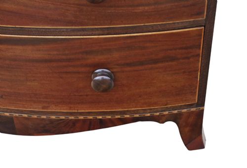 fig 3. A nineteenth century mahogany bow front chest of drawers with two short over three long graduated drawers, featuring turned timber handles and delicate boxwood stringing.