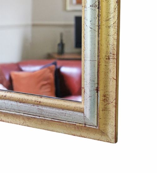 fig 1. A rectangular wall mirror featuring a moulded frame with a distressed gold and silver leaf finish.