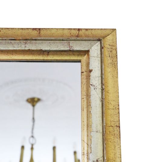 fig 2. A rectangular wall mirror featuring a moulded frame with a distressed gold and silver leaf finish.