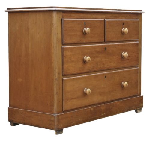 fig 1. Victorian pine chest of drawers featuring two short drawers over two long drawers with turned wooden knobs and keyhole escutcheons.