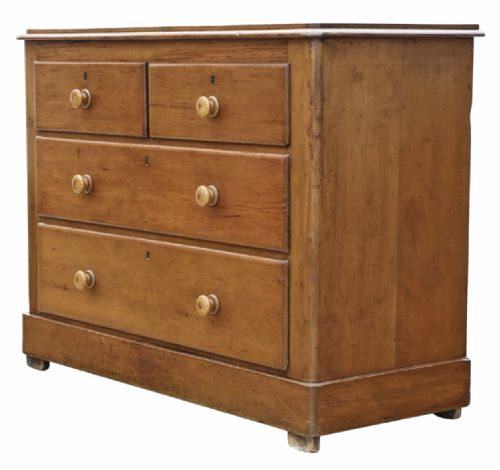 fig 2. Victorian pine chest of drawers featuring two short drawers over two long drawers with turned wooden knobs and keyhole escutcheons.