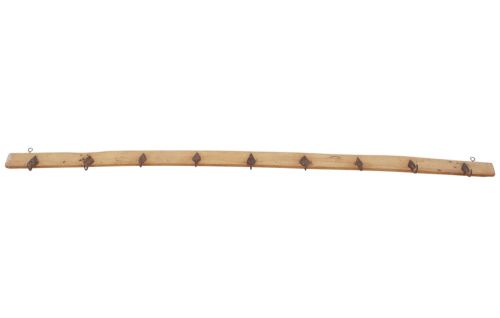 fig 4. A long horizontal pine timber rail fitted with nine spaced, hand-forged wrought iron hooks with pointed backplates.
