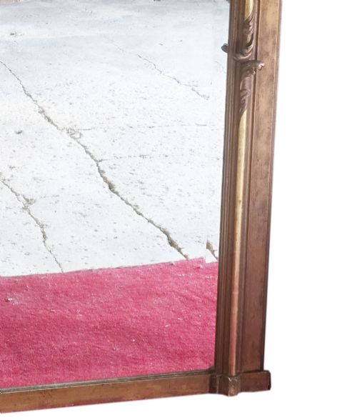 fig 3. A tall 19th-century gilded overmantel mirror featuring an arched frame, top cresting, and molded lattice frieze.