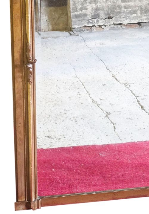 fig 4. A tall 19th-century gilded overmantel mirror featuring an arched frame, top cresting, and molded lattice frieze.