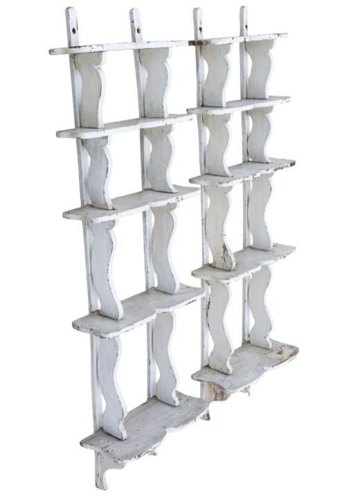 fig 1. A pair of 19th-century wall-mounted wooden shelves featuring five tiers with shaped, curved upright supports in a distressed white painted finish.