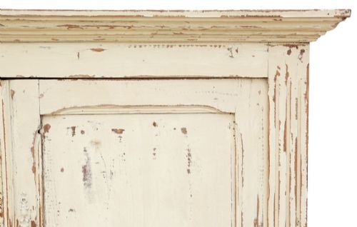 fig 5. A 19th-century two-tier wooden storage cupboard painted in distressed cream, featuring fluted side details, upper and lower double doors with fielded panels, and two central drawers.