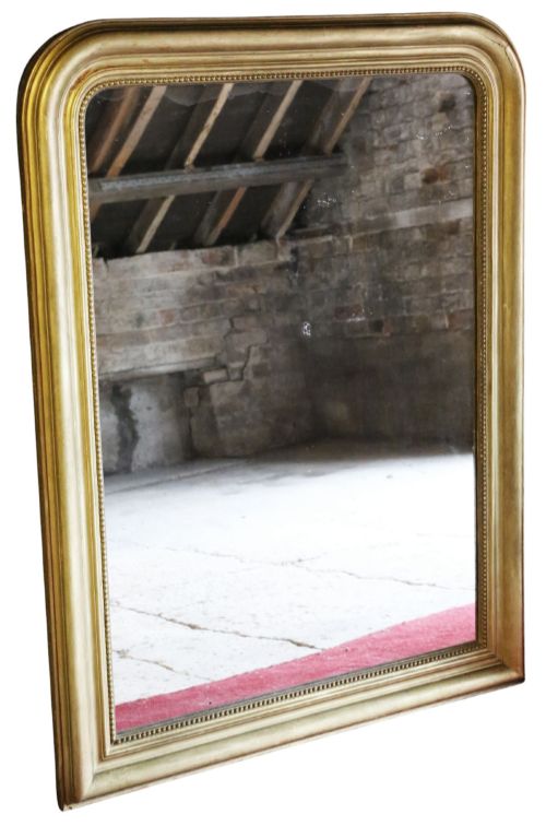 fig 1. A large rectangular gilt-framed wall mirror featuring rounded top corners and a beaded inner border.