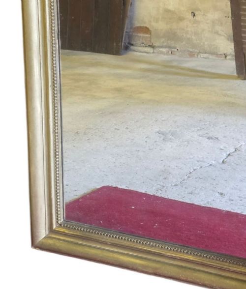 fig 5. A large rectangular gilt-framed wall mirror featuring rounded top corners and a beaded inner border.