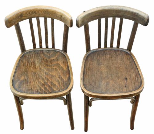 fig 3. A pair of dark brown bentwood bistro dining chairs featuring vertical back spindles, steam-bent frames, and contoured wood seats.
