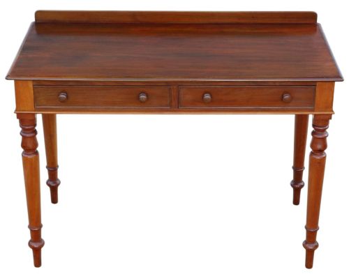 fig 1. A 19th-century mahogany writing and dressing table featuring two frieze drawers with turned handles, a low gallery back, and tapered turned legs.