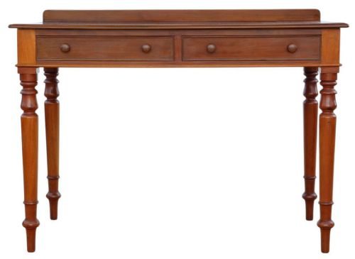 fig 3. A 19th-century mahogany writing and dressing table featuring two frieze drawers with turned handles, a low gallery back, and tapered turned legs.