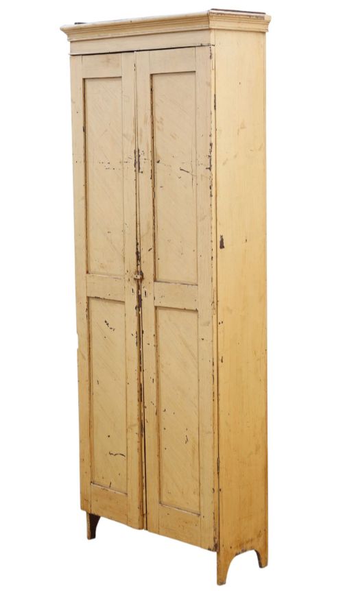 fig 4. A tall, narrow 19th-century cream painted pine housekeepers cupboard featuring double panelled doors, a moulded top cornice, and distressed paintwork.