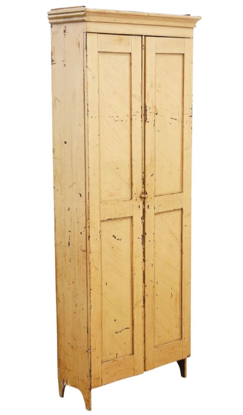 fig 5. A tall, narrow 19th-century cream painted pine housekeepers cupboard featuring double panelled doors, a moulded top cornice, and distressed paintwork.