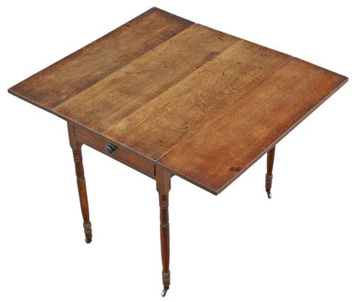 fig 1. A Georgian oak drop-leaf Pembroke table featuring turned legs, a single end drawer, and brass castors.