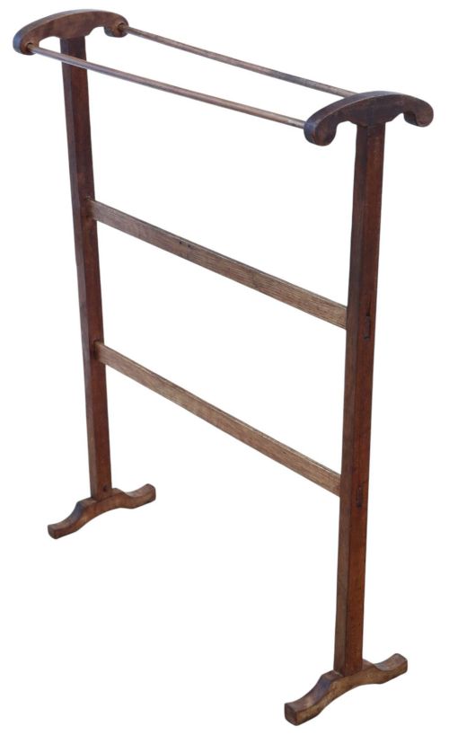 fig 1. An Edwardian wooden towel rail stand featuring dual top bars, curved side handles, middle cross braces, and splayed trestle feet.