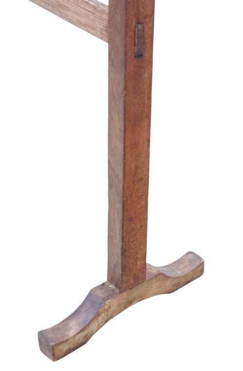 fig 3. An Edwardian wooden towel rail stand featuring dual top bars, curved side handles, middle cross braces, and splayed trestle feet.