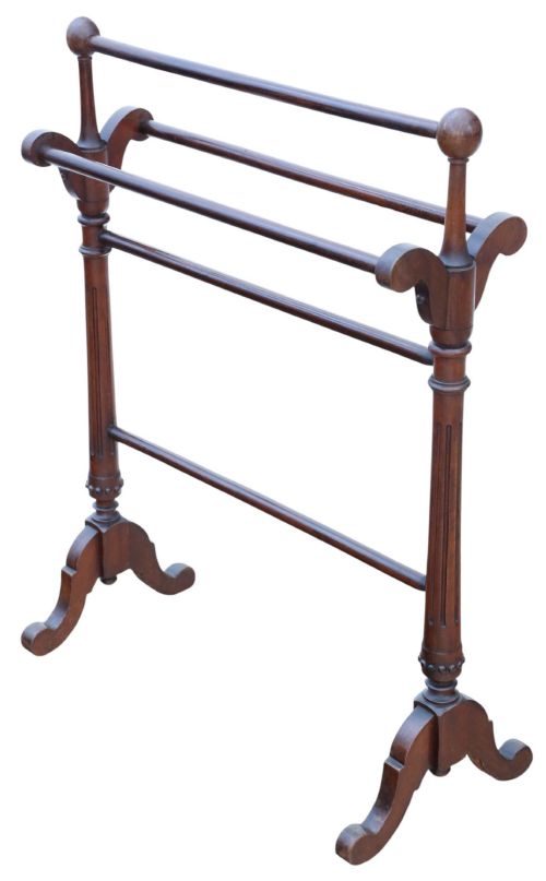 fig 1. A Victorian mahogany freestanding towel rail featuring turned top finials, multiple horizontal rails, fluted upright supports, and carved scroll feet.