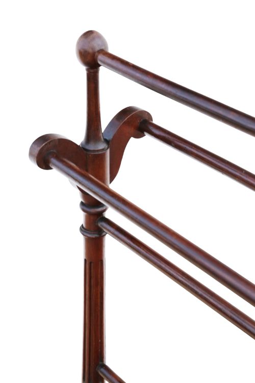 fig 3. A Victorian mahogany freestanding towel rail featuring turned top finials, multiple horizontal rails, fluted upright supports, and carved scroll feet.