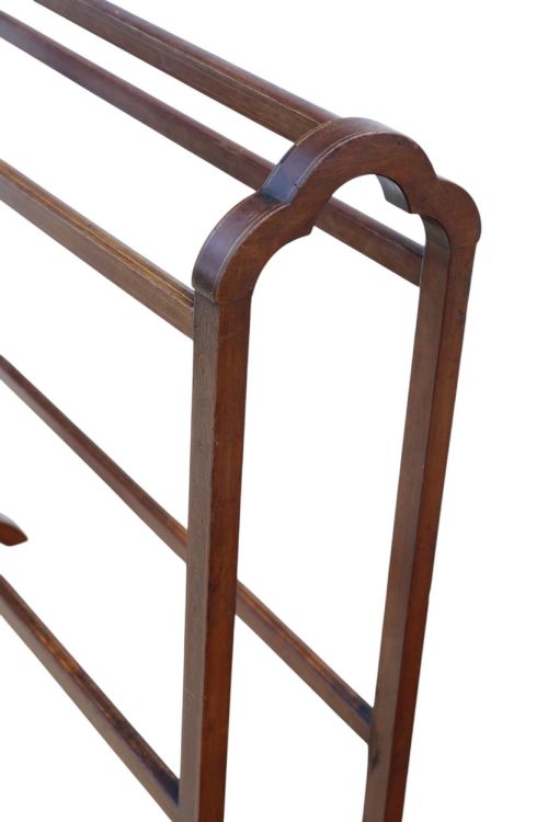 fig 2. An Edwardian mahogany towel rail featuring arched side supports, fine line inlay, three upper hanging bars, lower stretchers, and splayed feet.
