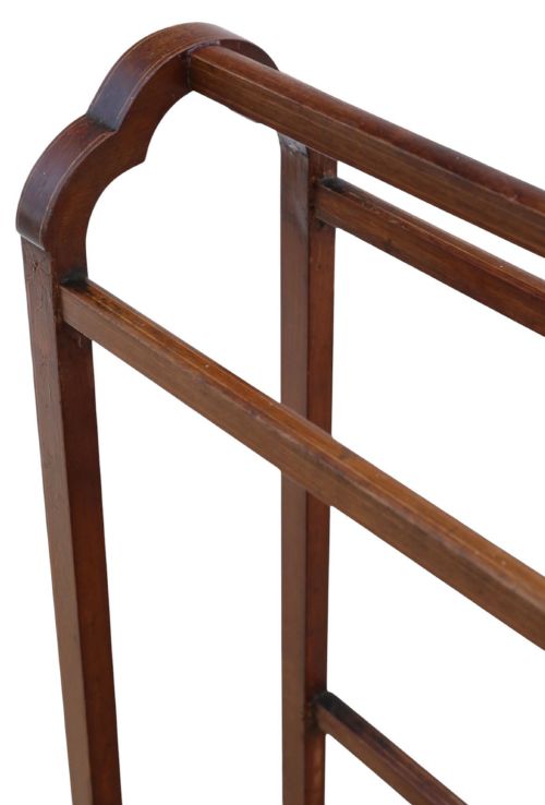 fig 3. An Edwardian mahogany towel rail featuring arched side supports, fine line inlay, three upper hanging bars, lower stretchers, and splayed feet.