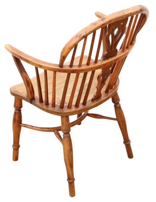 fig 2. A 19th-century yew and elm Windsor armchair featuring a hoop back, pierced central splat, turned legs, and a crinoline stretcher.