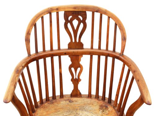 fig 3. A 19th-century yew and elm Windsor armchair featuring a hoop back, pierced central splat, turned legs, and a crinoline stretcher.