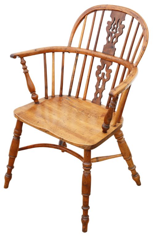 fig 1. A nineteenth-century wooden Windsor armchair featuring a curved hoop back, a decorative central splat, shaped elm seat, and turned legs with a crinoline stretcher.