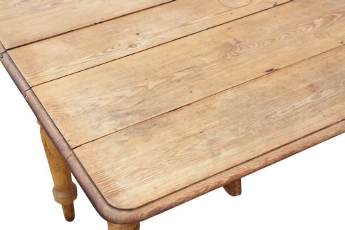 fig 4. A 19th-century Victorian pine drop-leaf table featuring turned legs, a planked top surface, and a single end drawer with a wooden knob handle.