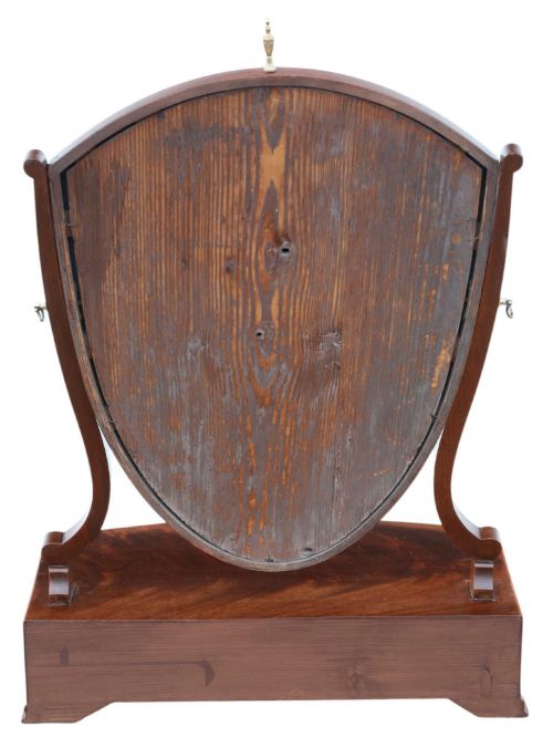 fig 4. A 19th-century Georgian mahogany swing mirror featuring a shield-shaped frame supported by curved uprights over a shaped base with three small drawers.