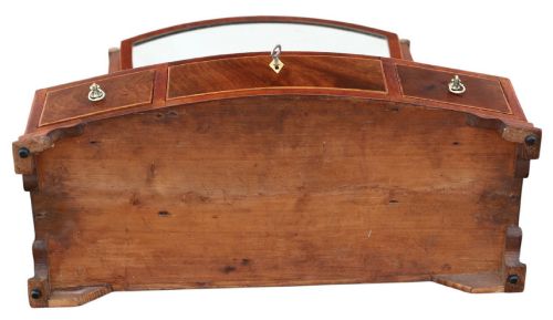 fig 5. A 19th-century Georgian mahogany swing mirror featuring a shield-shaped frame supported by curved uprights over a shaped base with three small drawers.