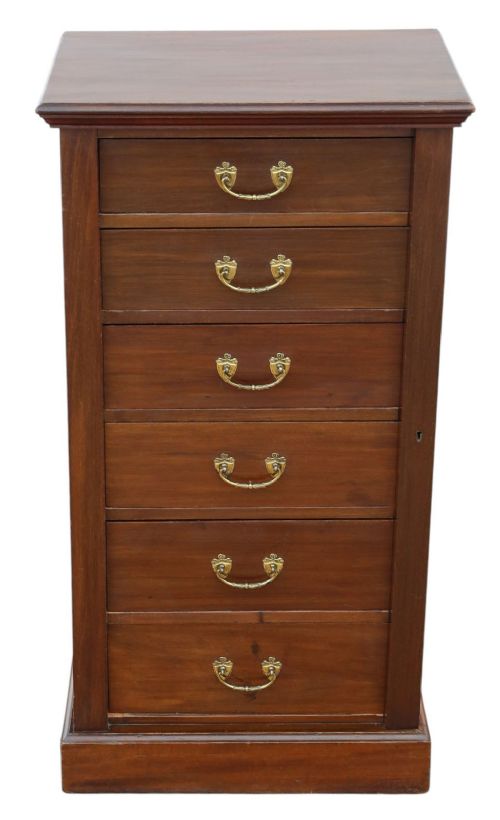 fig 1. A tall mahogany Wellington chest featuring six drawers with brass handles and a right-side locking pilaster on a plinth base.