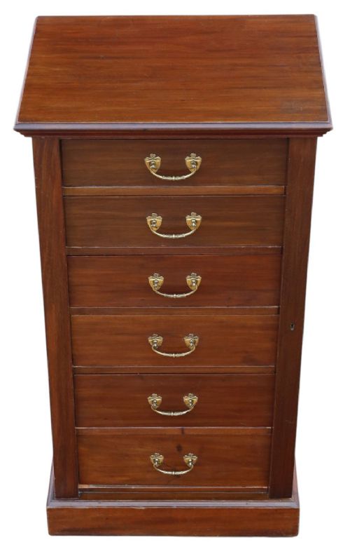 fig 2. A tall mahogany Wellington chest featuring six drawers with brass handles and a right-side locking pilaster on a plinth base.