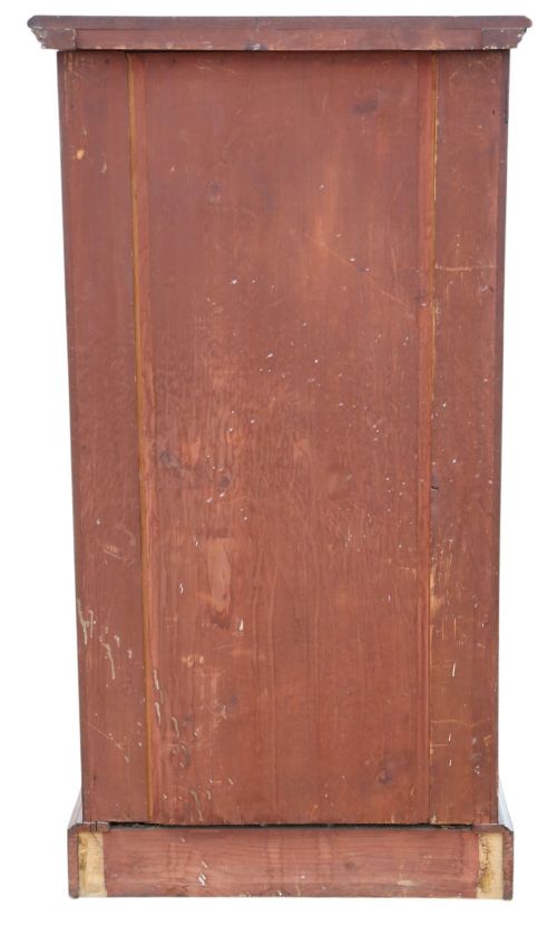 fig 5. A tall mahogany Wellington chest featuring six drawers with brass handles and a right-side locking pilaster on a plinth base.