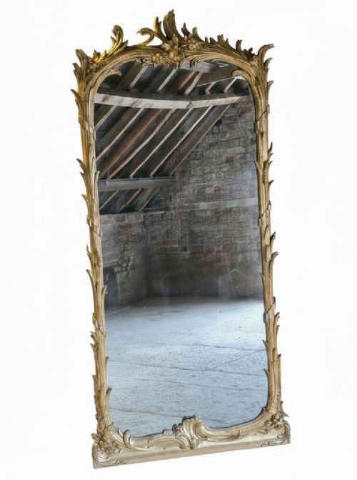 fig 1. A large 19th-century tall wall mirror featuring an ornate gilded wood frame with hand-carved acanthus leaf cresting and scrollwork.