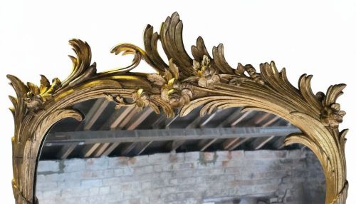 fig 2. A large 19th-century tall wall mirror featuring an ornate gilded wood frame with hand-carved acanthus leaf cresting and scrollwork.