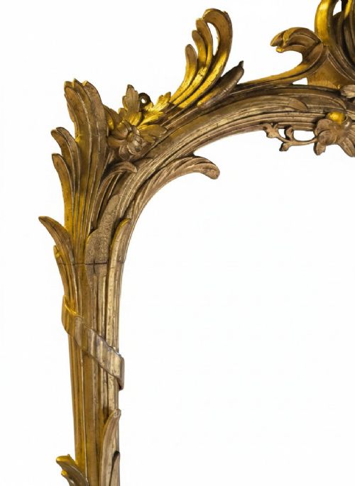 fig 4. A large 19th-century tall wall mirror featuring an ornate gilded wood frame with hand-carved acanthus leaf cresting and scrollwork.