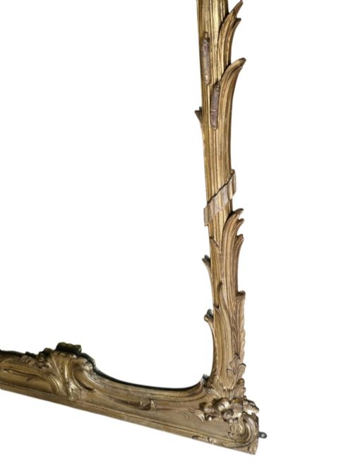 fig 5. A large 19th-century tall wall mirror featuring an ornate gilded wood frame with hand-carved acanthus leaf cresting and scrollwork.