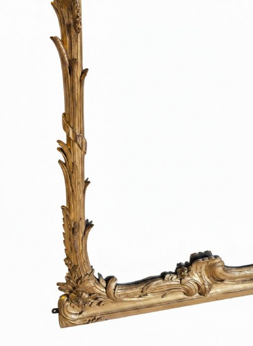 A large 19th-century tall wall mirror featuring an ornate gilded wood frame with hand-carved acanthus leaf cresting and scrollwork. View VIII