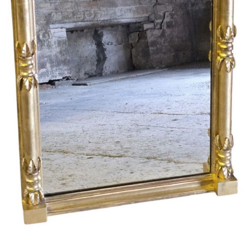 fig 2. A rectangular 19th-century Regency giltwood pier mirror featuring a breakfront cornice with sphere mouldings, lion mask corner blocks, and detailed column sides.