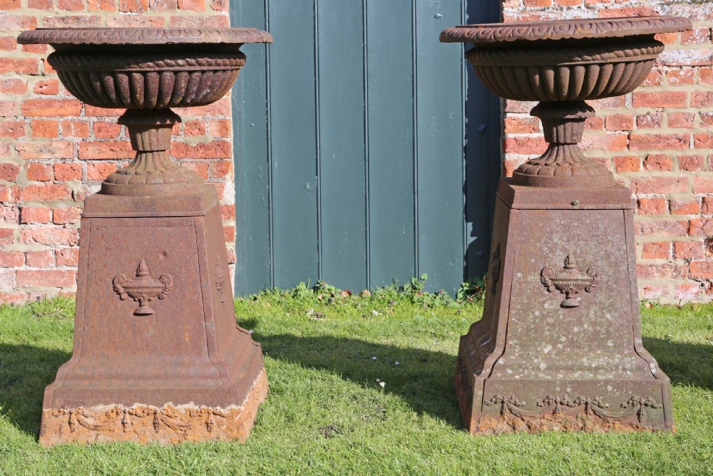 Pair of Victorian cast iron planters classical urns on plinths