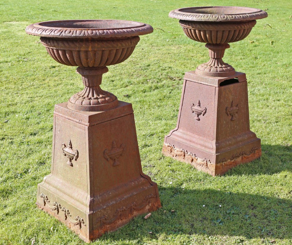 Pair of Victorian cast iron planters classical urns on plinths View IV