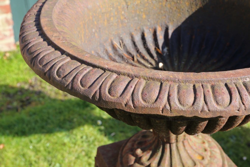 Pair of Victorian cast iron planters classical urns on plinths View V