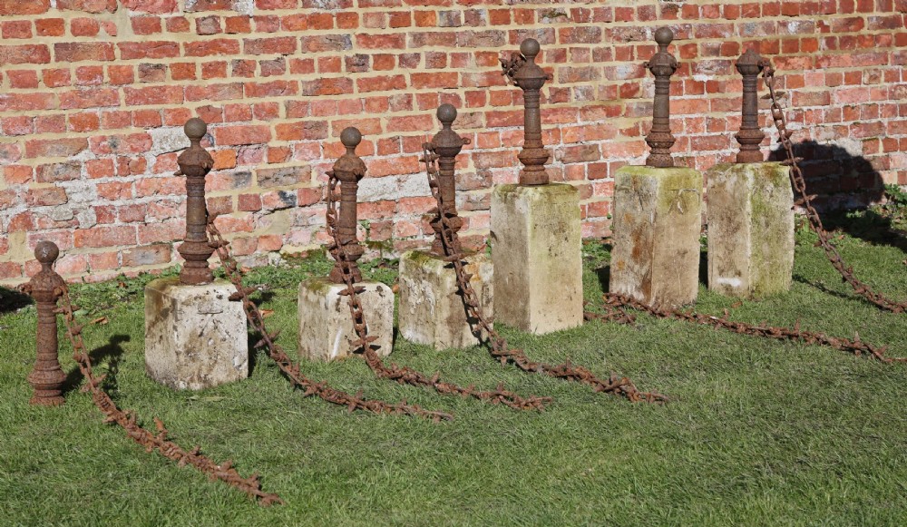 Set of 7 cast iron bollards with stone bases View III