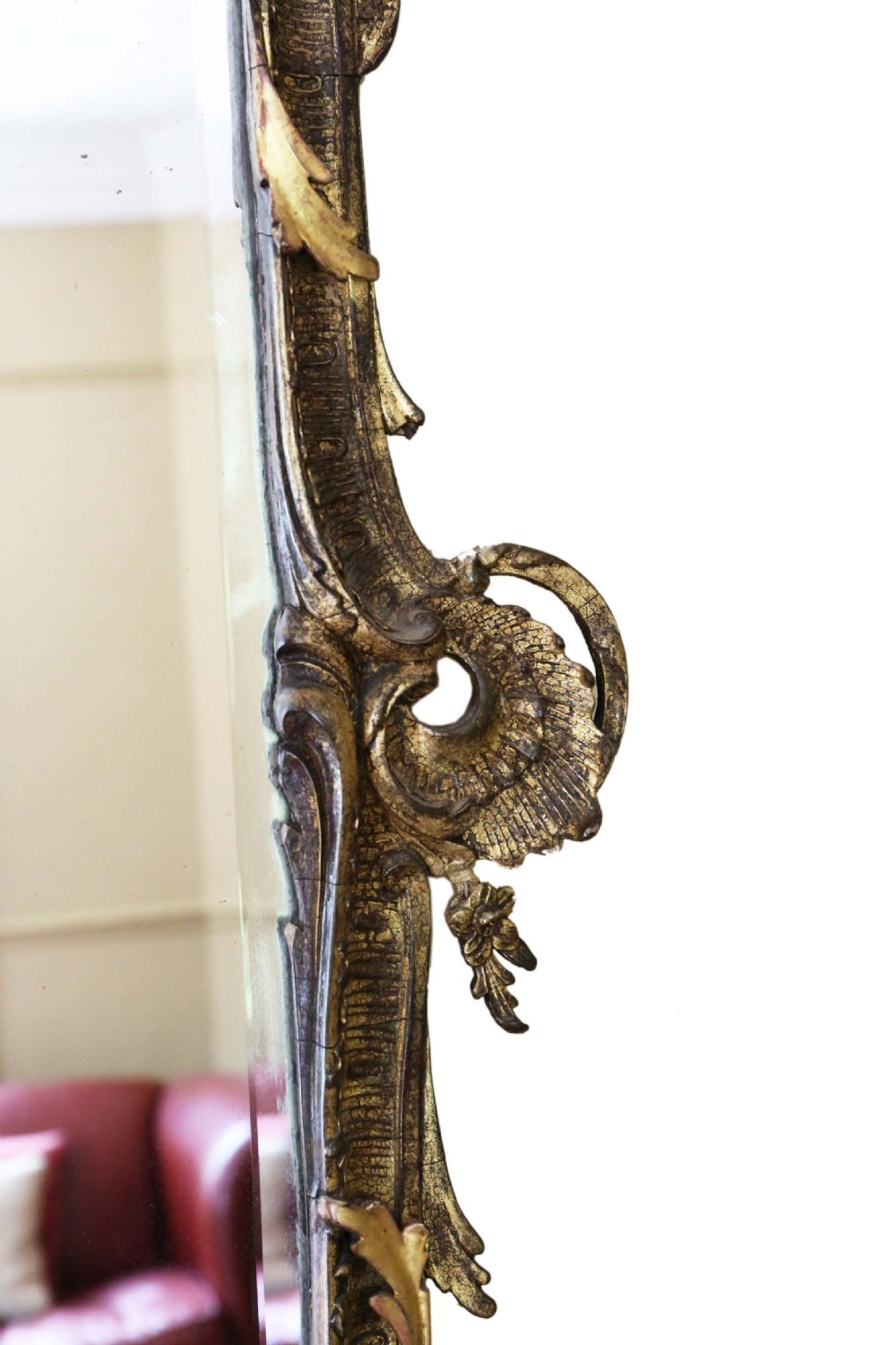 An ornate early 19th-century Rococo Revival style rectangular giltwood wall mirror featuring elaborate scrolling acanthus leaf carvings and a central shell cresting. View V