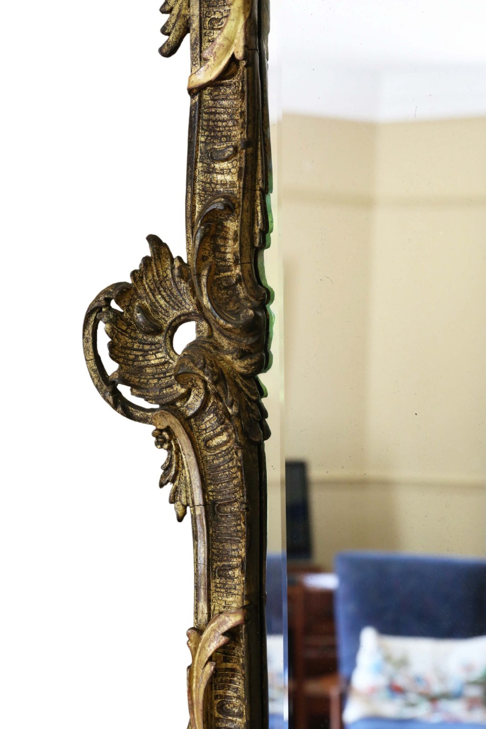 An ornate early 19th-century Rococo Revival style rectangular giltwood wall mirror featuring elaborate scrolling acanthus leaf carvings and a central shell cresting. View VI