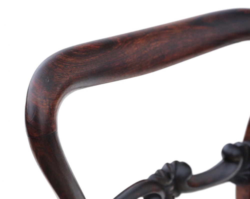 A set of six Victorian rosewood balloon back dining chairs featuring carved central splats, turned front legs, and cream upholstered seats. View VII