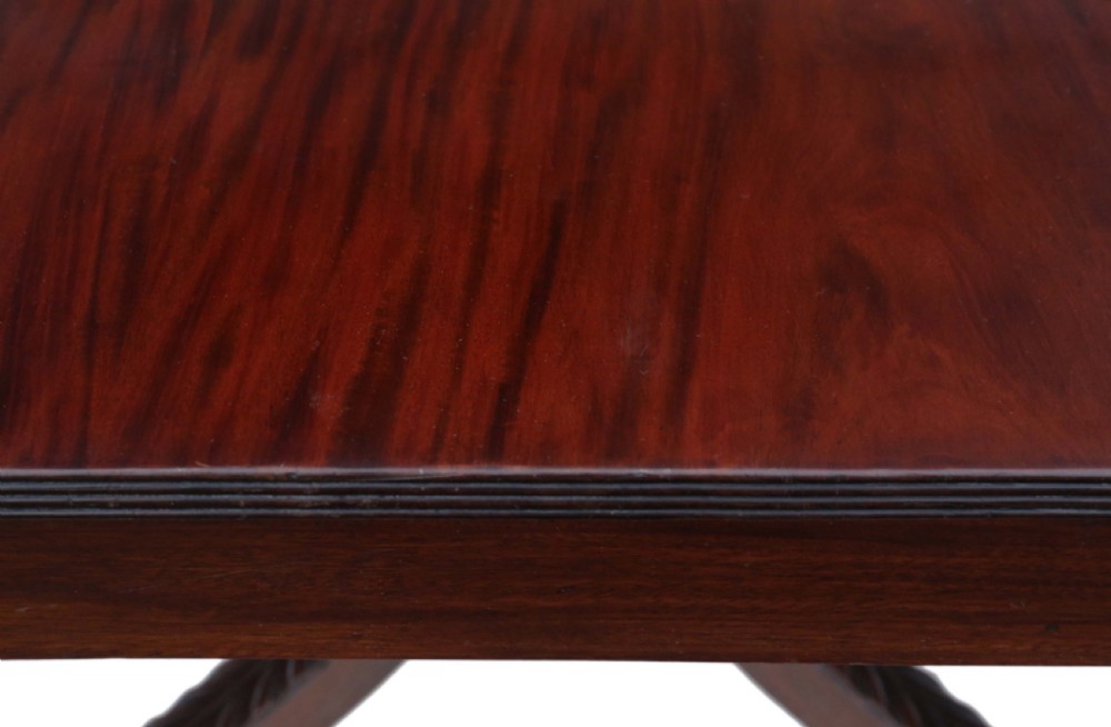 A Regency period Cuban mahogany drop leaf dining table extended with a central pedestal and four reeded splayed legs on brass castors. View XI