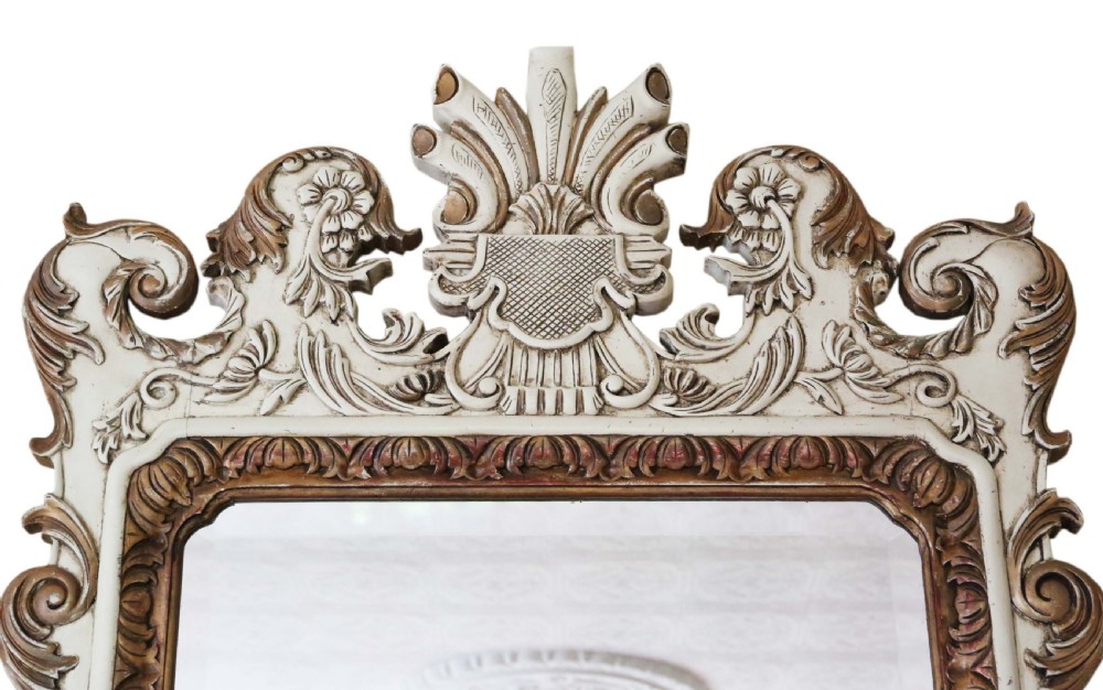 Large early 20th-century Rococo Revival overmantel wall mirror with an off-white frame, gold leaf highlights, and an ornate crested top. View II