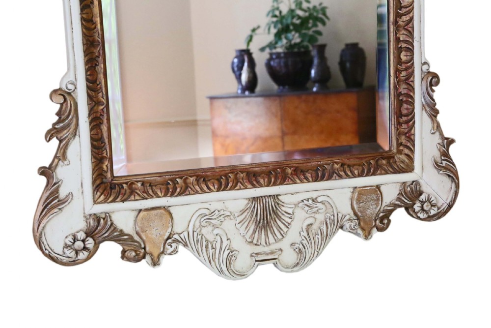 Large early 20th-century Rococo Revival overmantel wall mirror with an off-white frame, gold leaf highlights, and an ornate crested top. View IV
